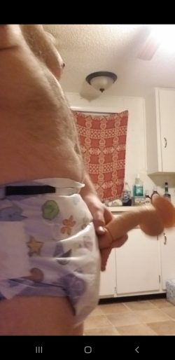 Diapered sissy playes with toy